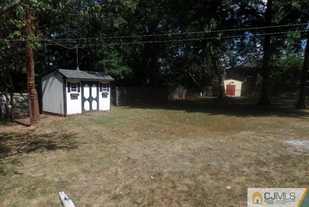 195 Midfield Road Colonia, NJ 07067 - Photo 17 of 21 a front view of a house with a yard