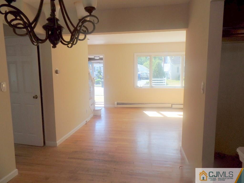 195 Midfield Road Colonia, NJ 07067 - Photo 6 of 21 a view of empty room with wooden floor and fan
