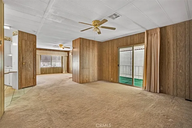 a view of a livingroom with a ceiling fan and window