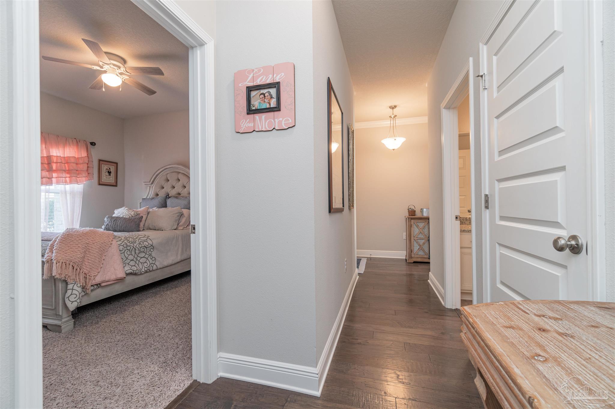 7997 Woodbrook Road Pensacola, FL 32526 - Photo 12 of 35 a bedroom with a bed and a walk in closet