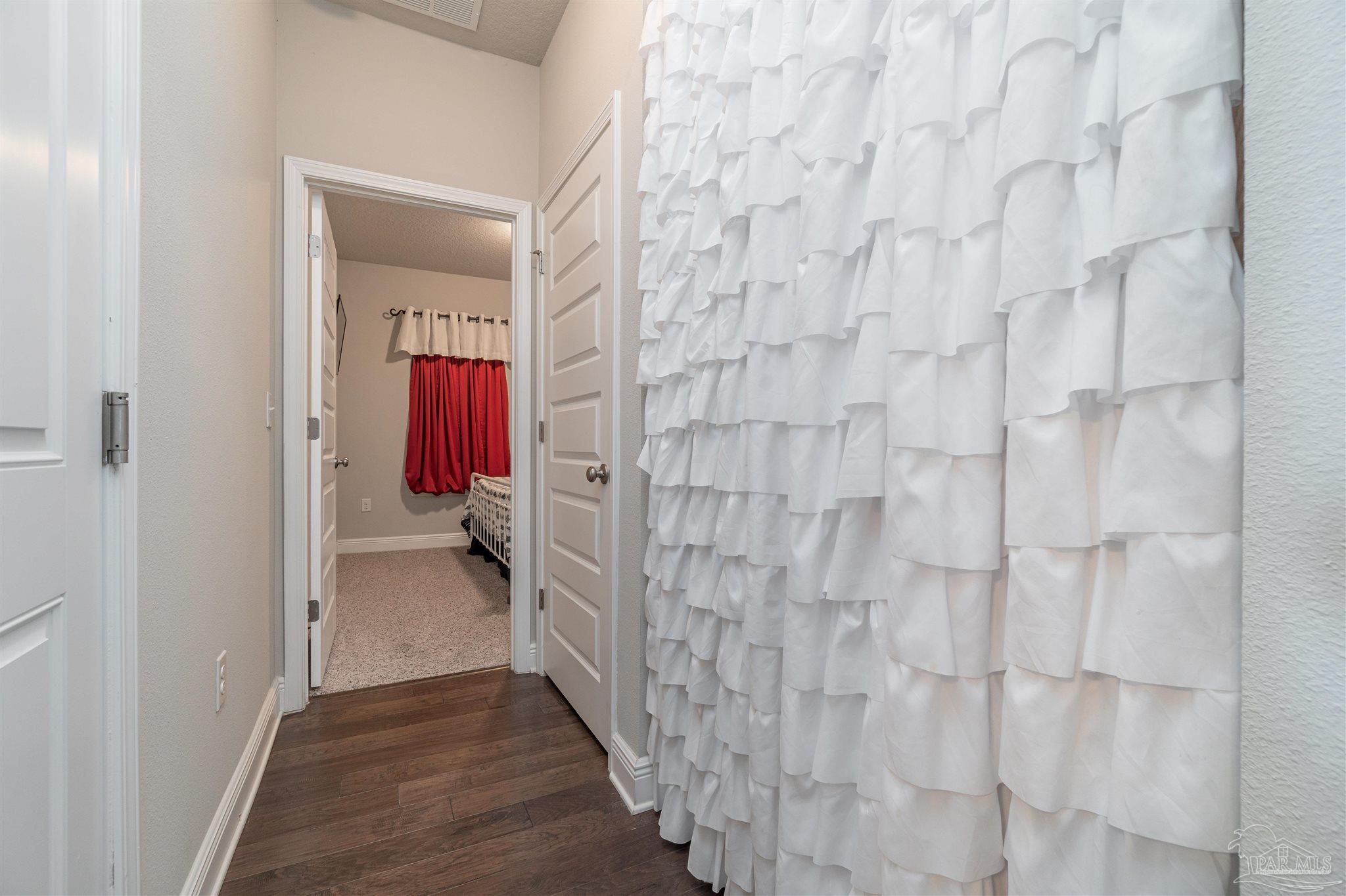 7997 Woodbrook Road Pensacola, FL 32526 - Photo 16 of 35 a view of a bathroom from a hallway