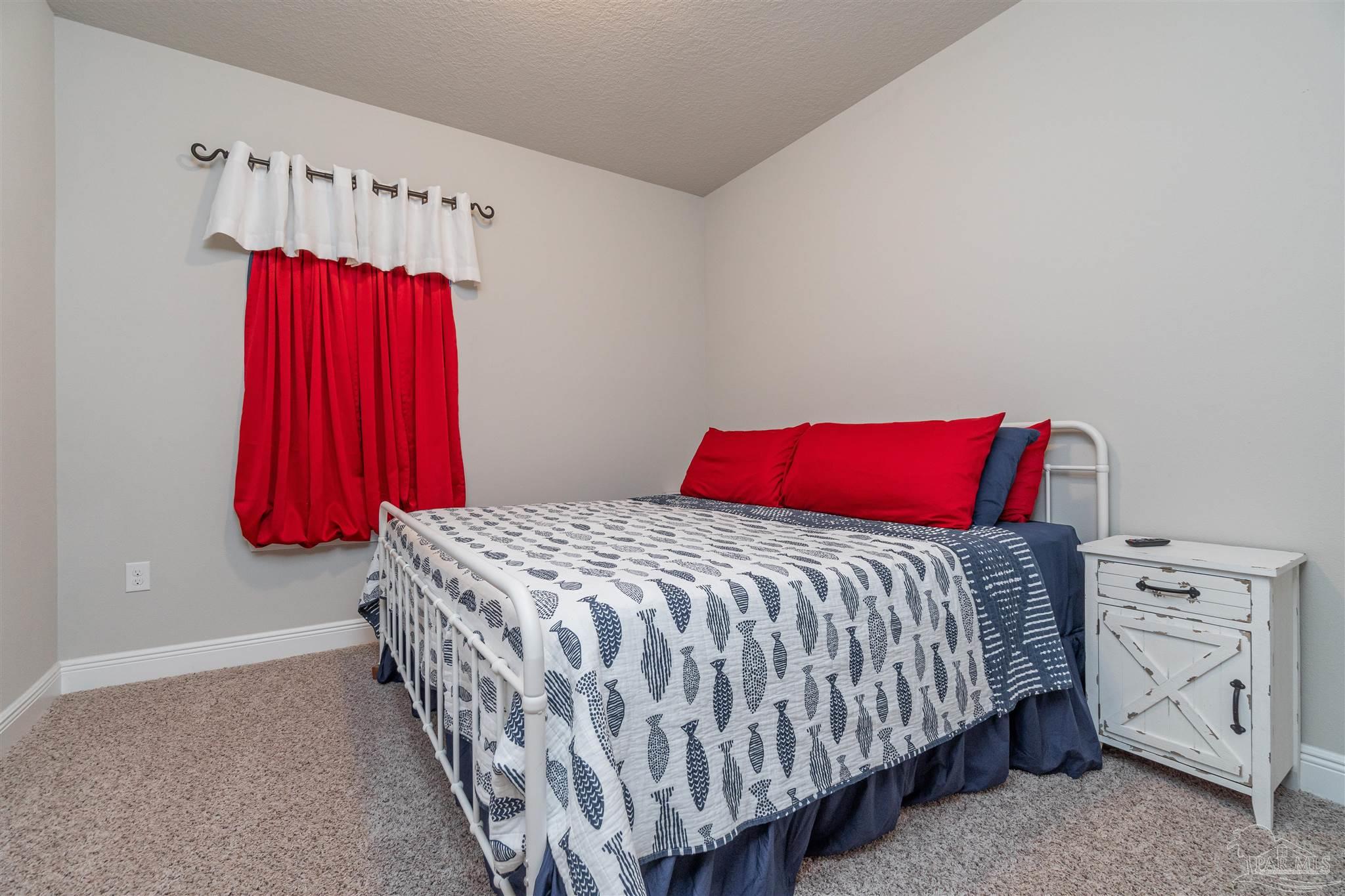 7997 Woodbrook Road Pensacola, FL 32526 - Photo 17 of 35 a bedroom with a bed and a window