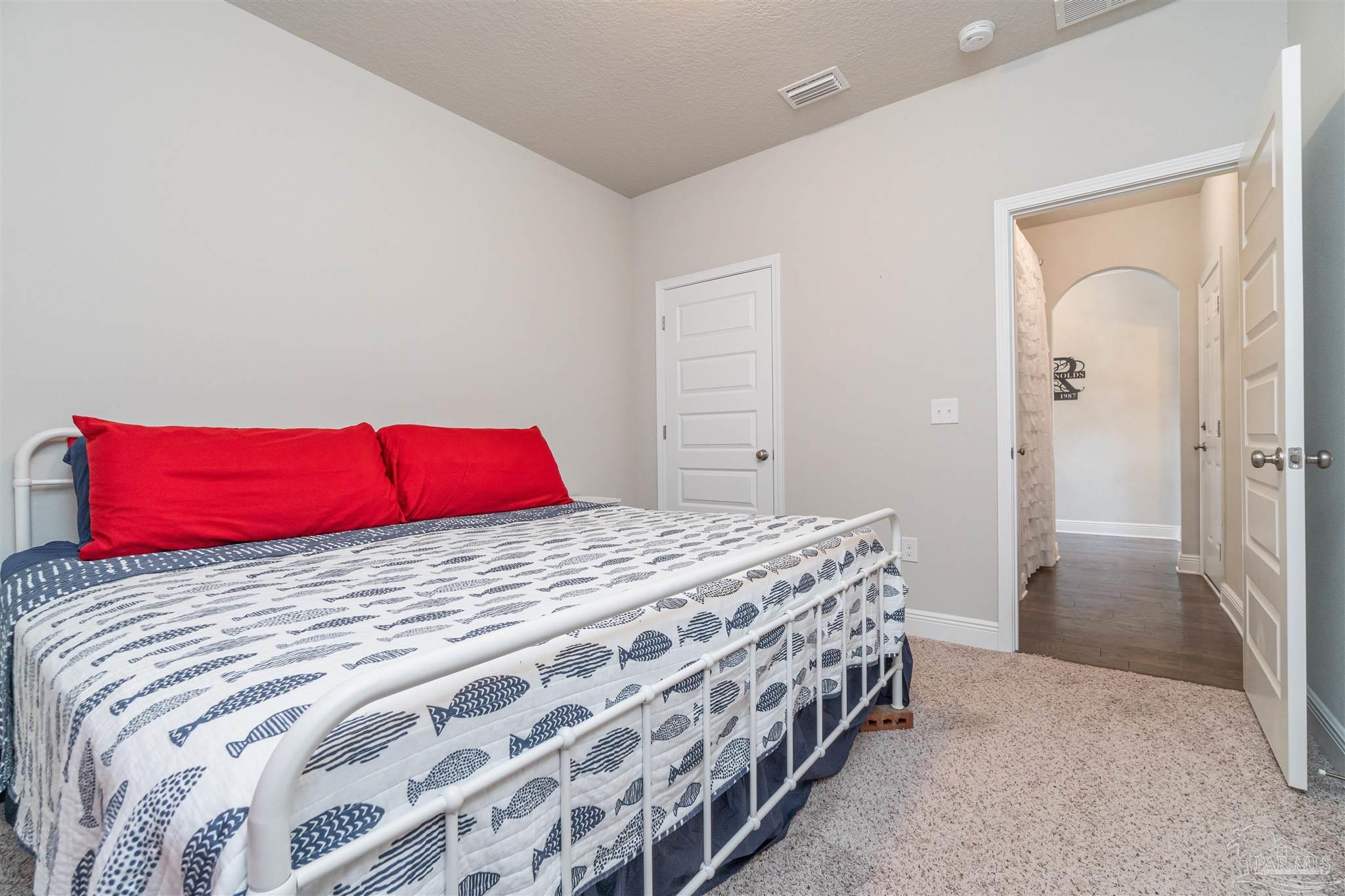 7997 Woodbrook Road Pensacola, FL 32526 - Photo 18 of 35 a bedroom with a bed and a large mirror