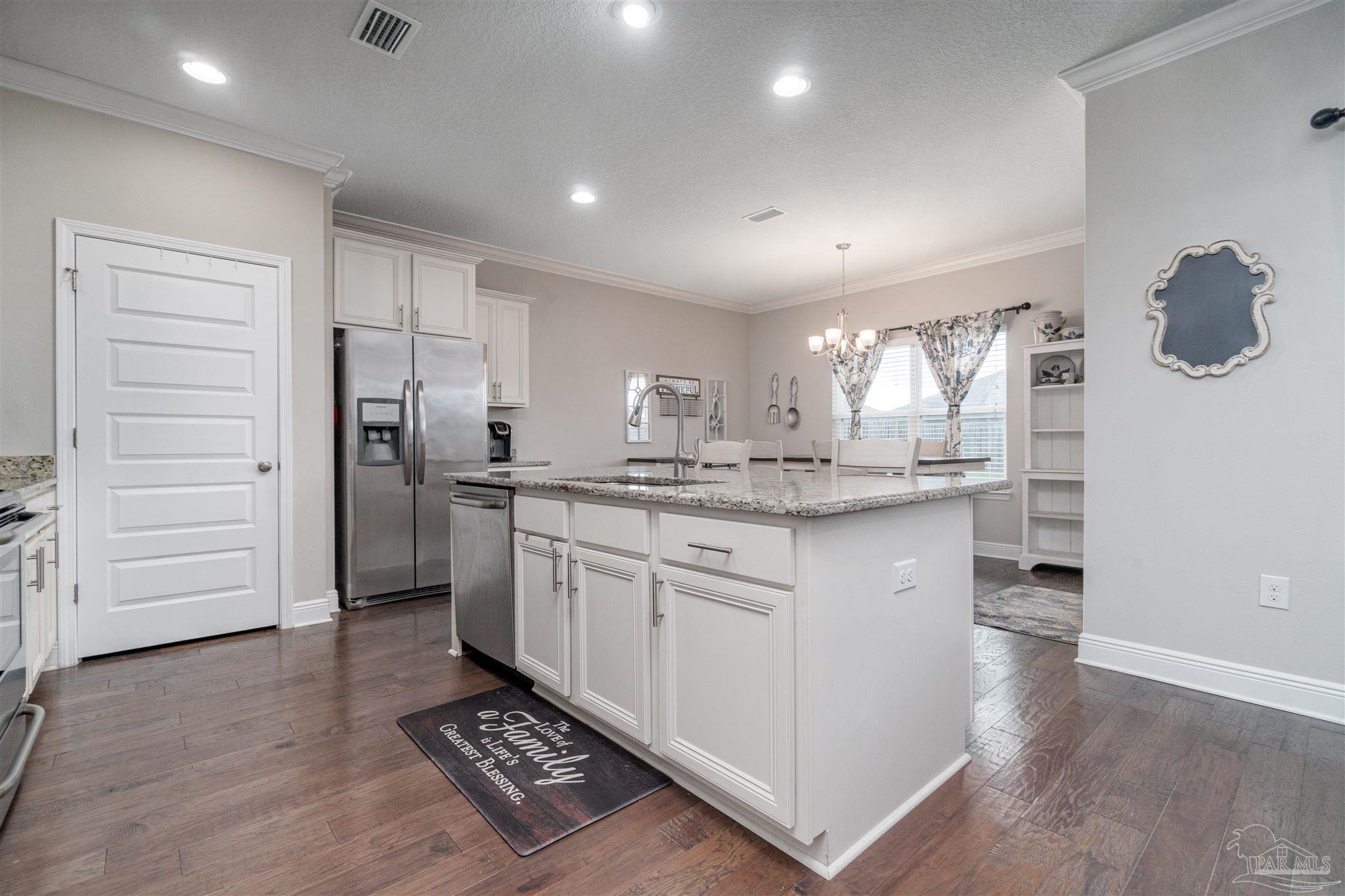 7997 Woodbrook Road Pensacola, FL 32526 - Photo 19 of 35 a kitchen with kitchen island cabinets and appliances