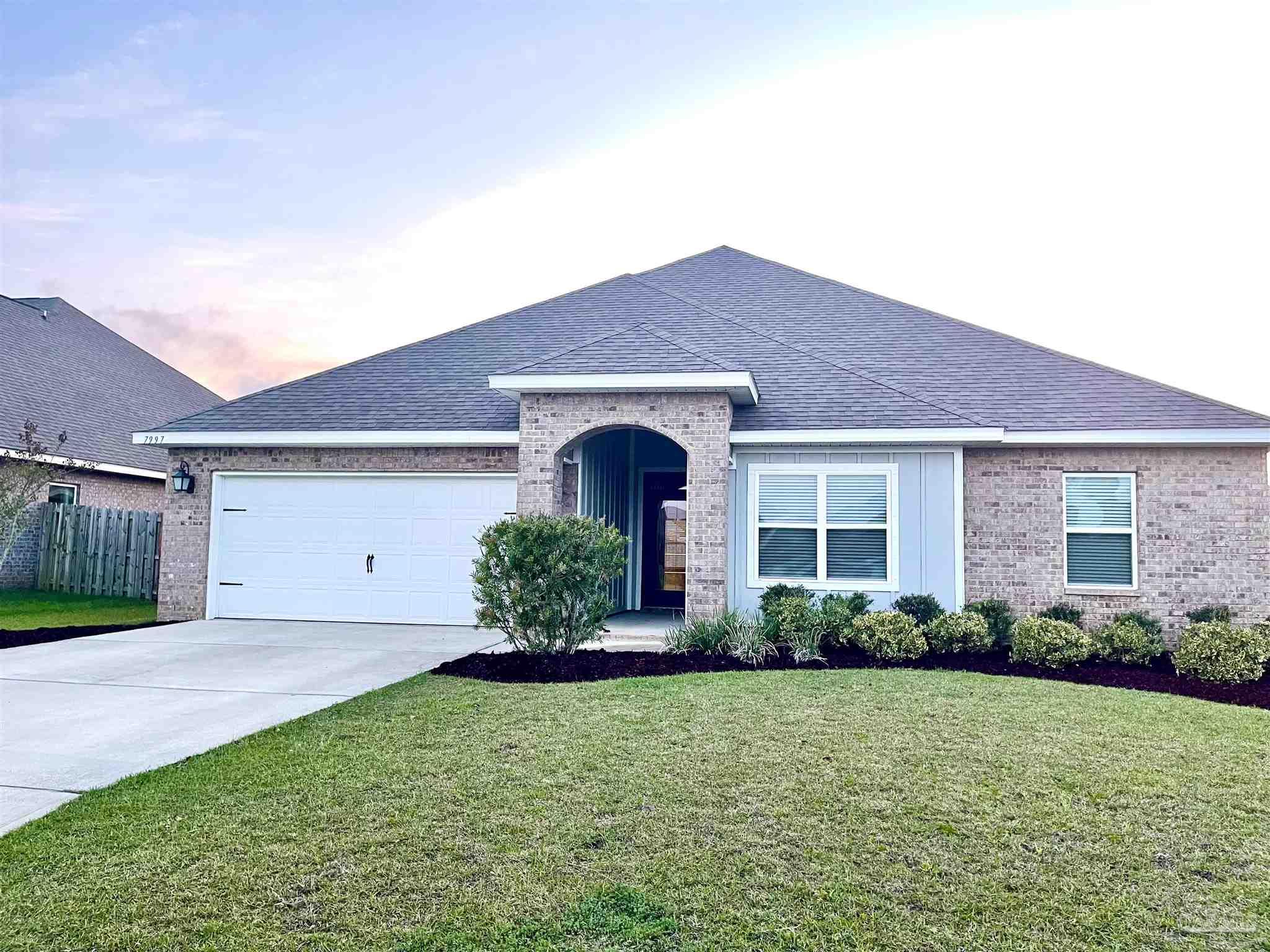 7997 Woodbrook Road Pensacola, FL 32526 - Photo 2 of 35 a front view of a house with garden