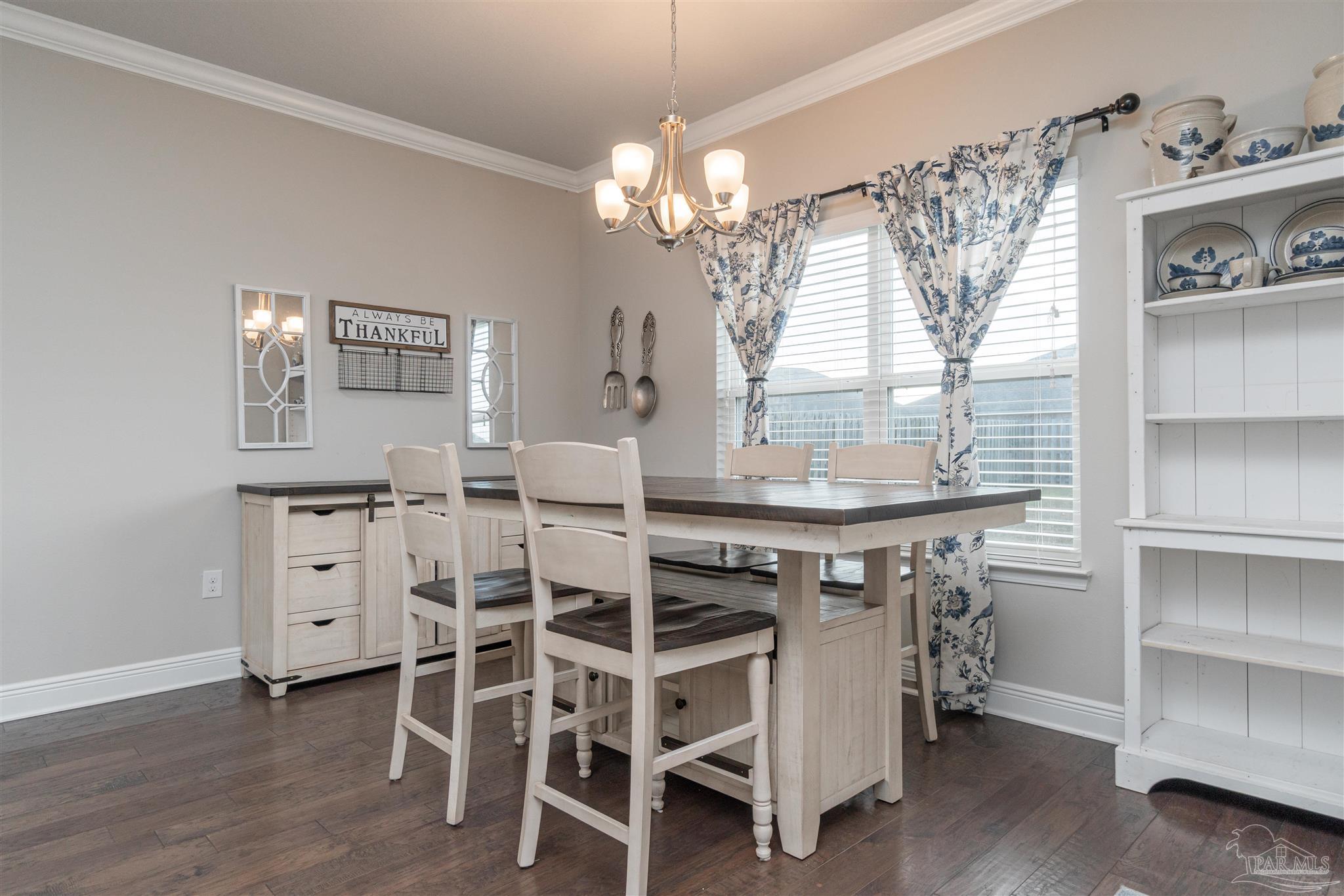 7997 Woodbrook Road Pensacola, FL 32526 - Photo 21 of 35 a view of a dining room with furniture and chandelier