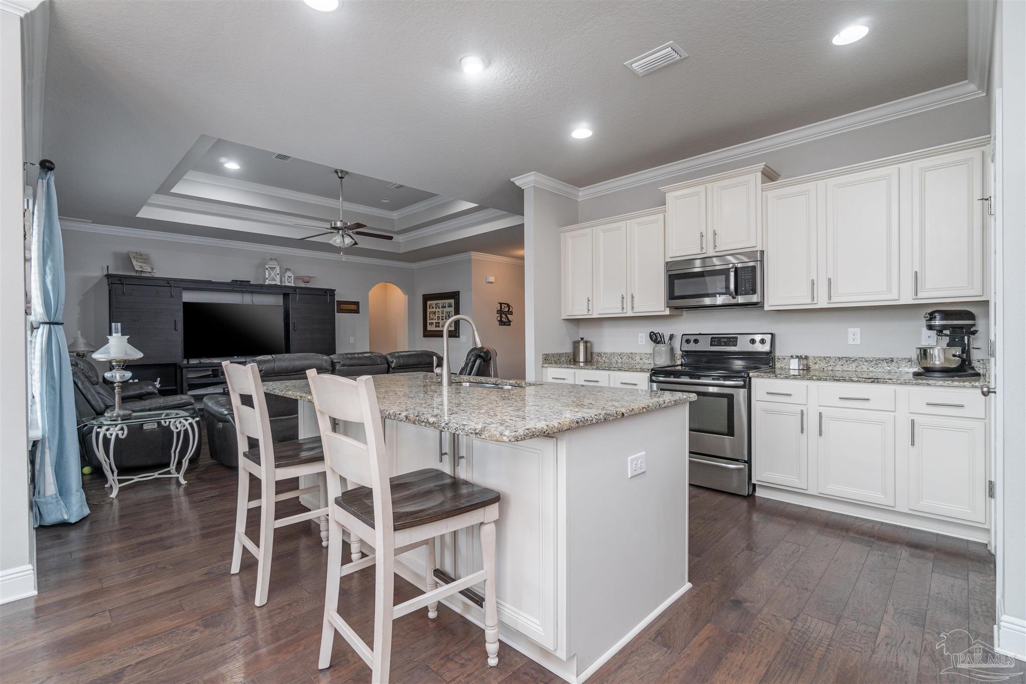 7997 Woodbrook Road Pensacola, FL 32526 - Photo 22 of 35 a kitchen with stainless steel appliances kitchen island granite countertop a sink and cabinets