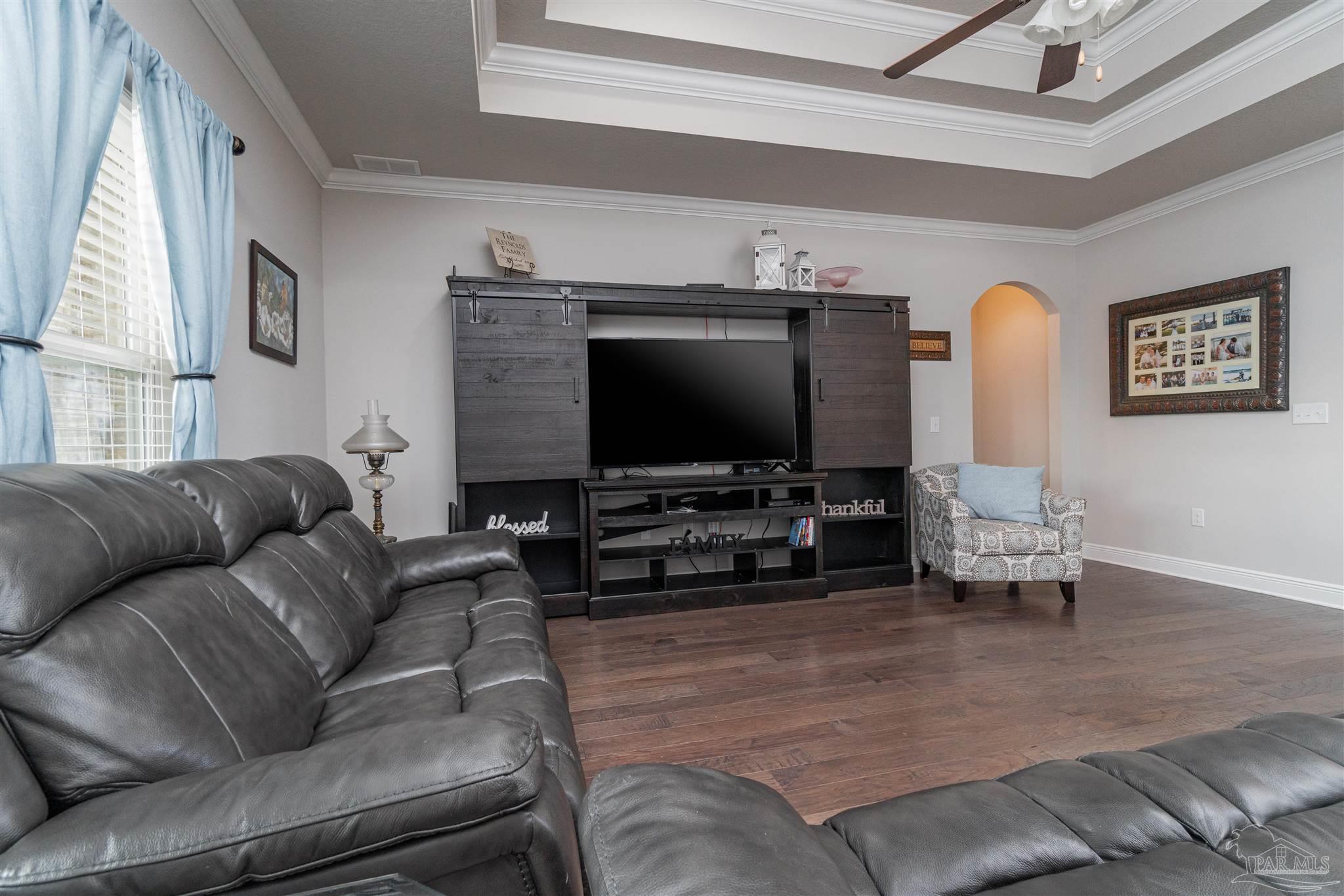 7997 Woodbrook Road Pensacola, FL 32526 - Photo 23 of 35 a living room with furniture and a flat screen tv