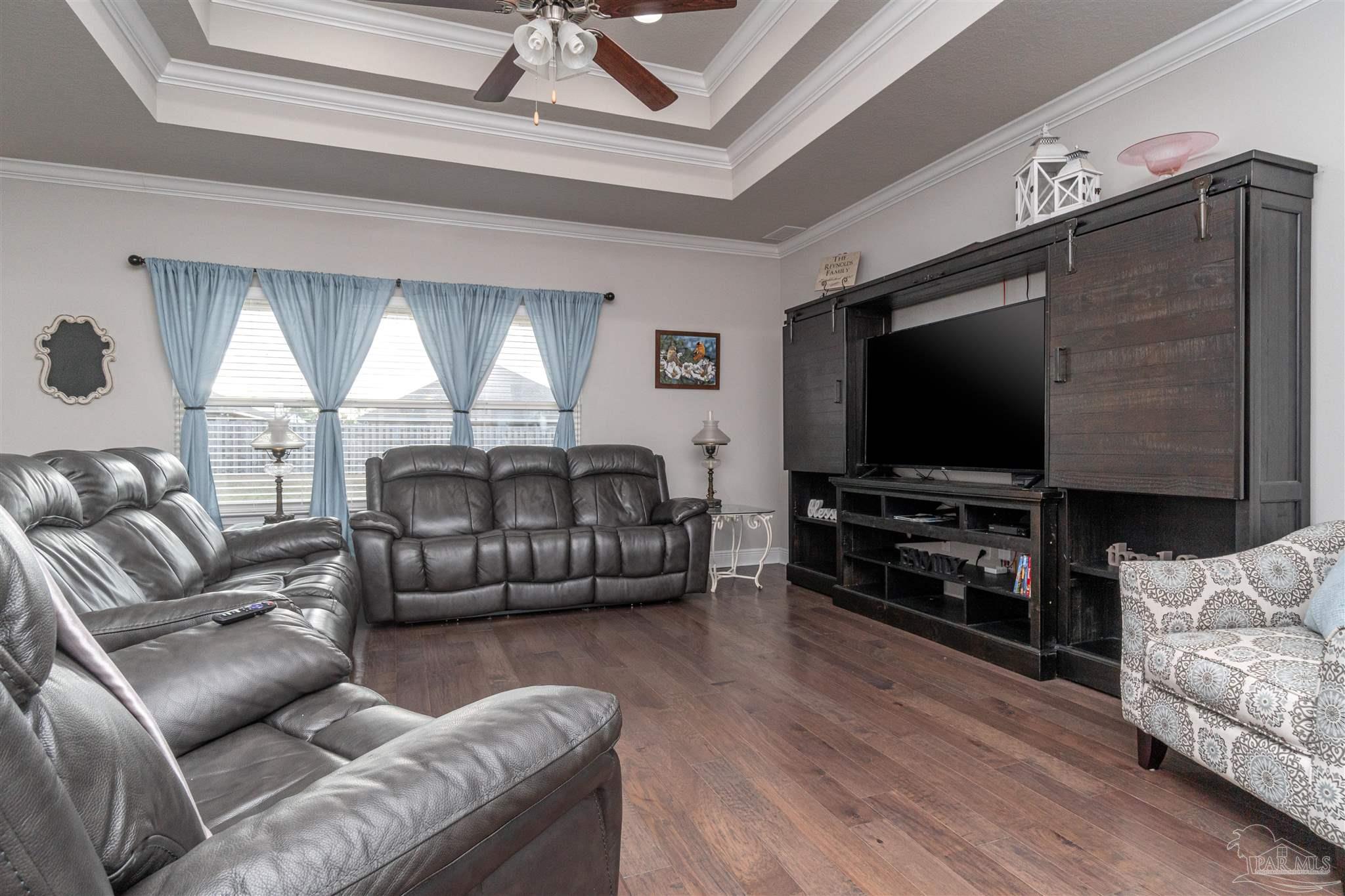 7997 Woodbrook Road Pensacola, FL 32526 - Photo 24 of 35 a living room with furniture and a flat screen tv