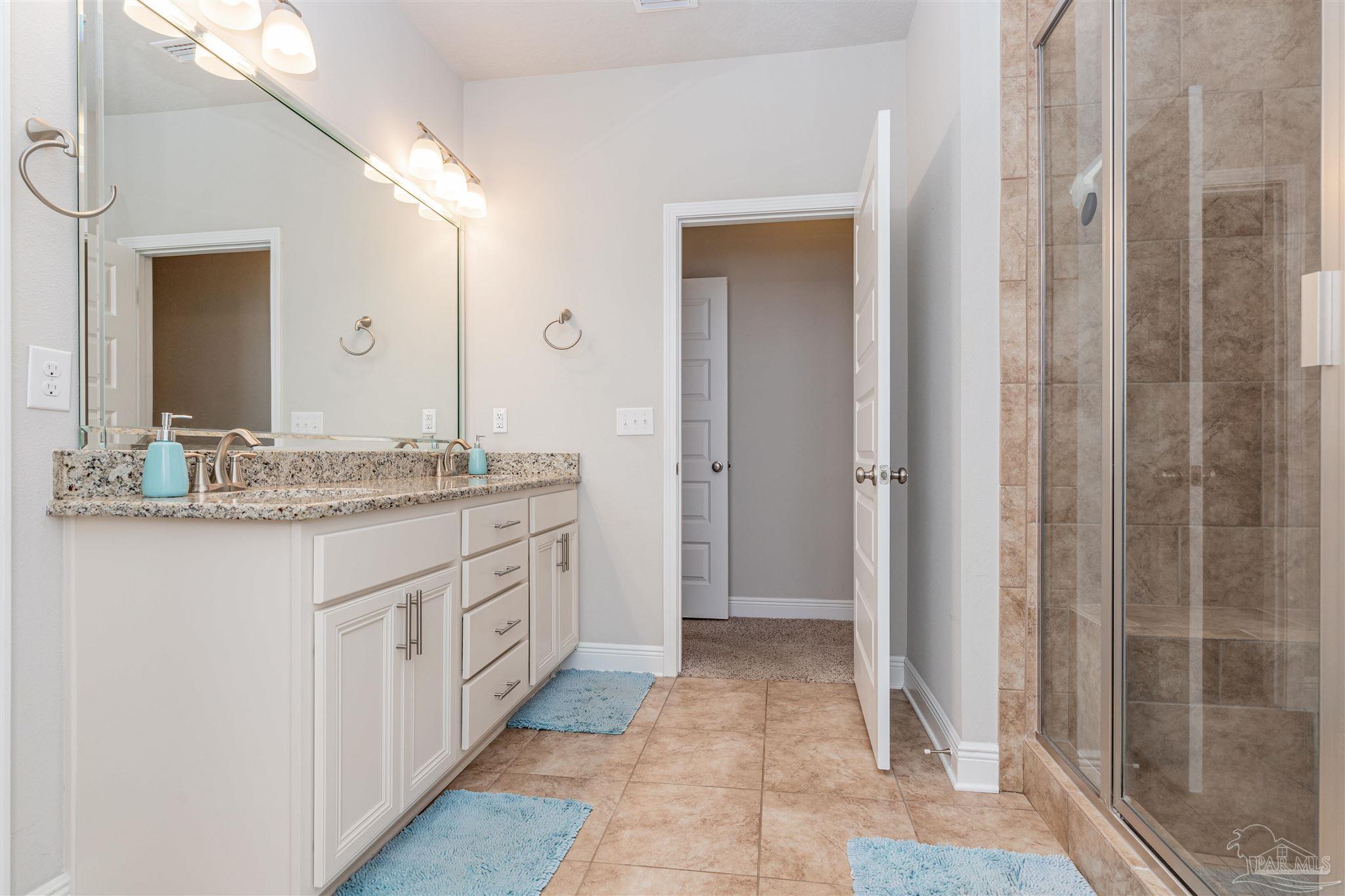 7997 Woodbrook Road Pensacola, FL 32526 - Photo 27 of 35 a bathroom with a granite countertop sink and a mirror