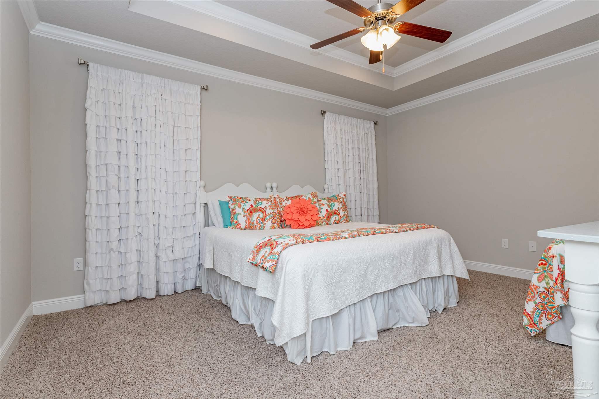 7997 Woodbrook Road Pensacola, FL 32526 - Photo 30 of 35 a bedroom with a bed and ceiling fan
