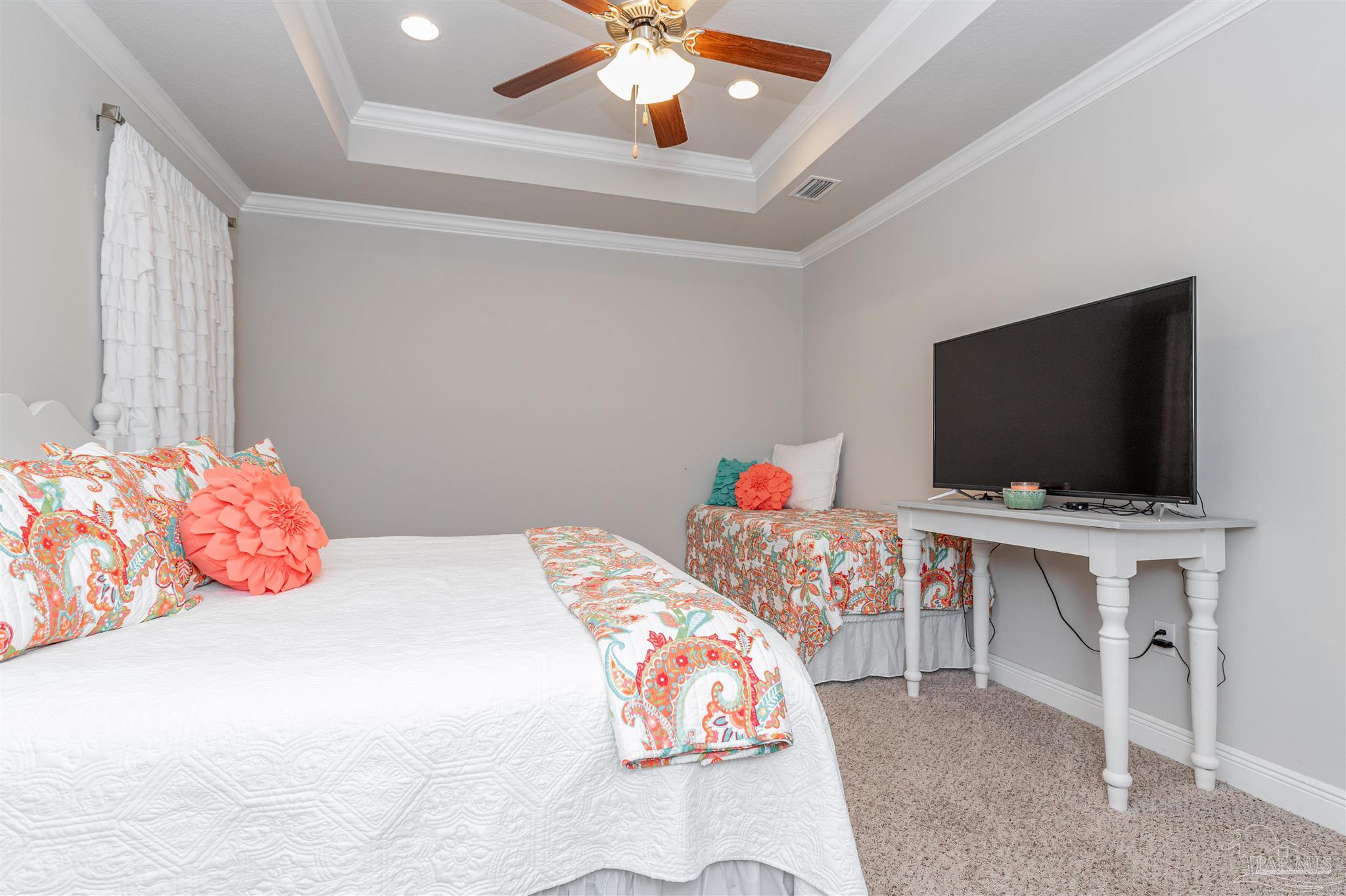 7997 Woodbrook Road Pensacola, FL 32526 - Photo 31 of 35 a bedroom with a bed and a flat screen tv
