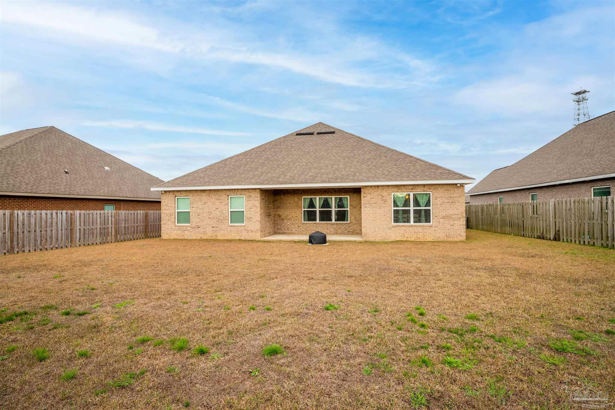 7997 Woodbrook Road Pensacola, FL 32526 - Photo 35 of 35 a front view of house with yard and trees in the background
