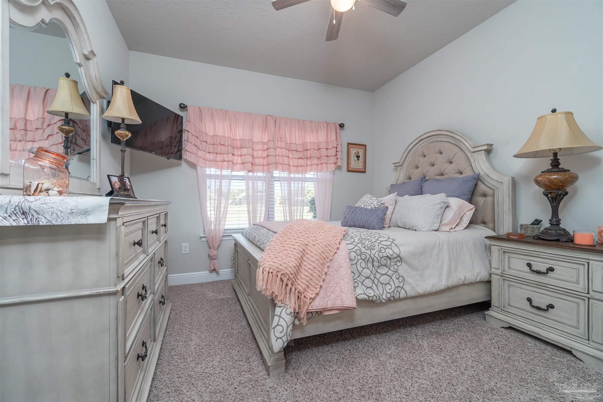 7997 Woodbrook Road Pensacola, FL 32526 - Photo 5 of 35 a bedroom with a bed and a dresser