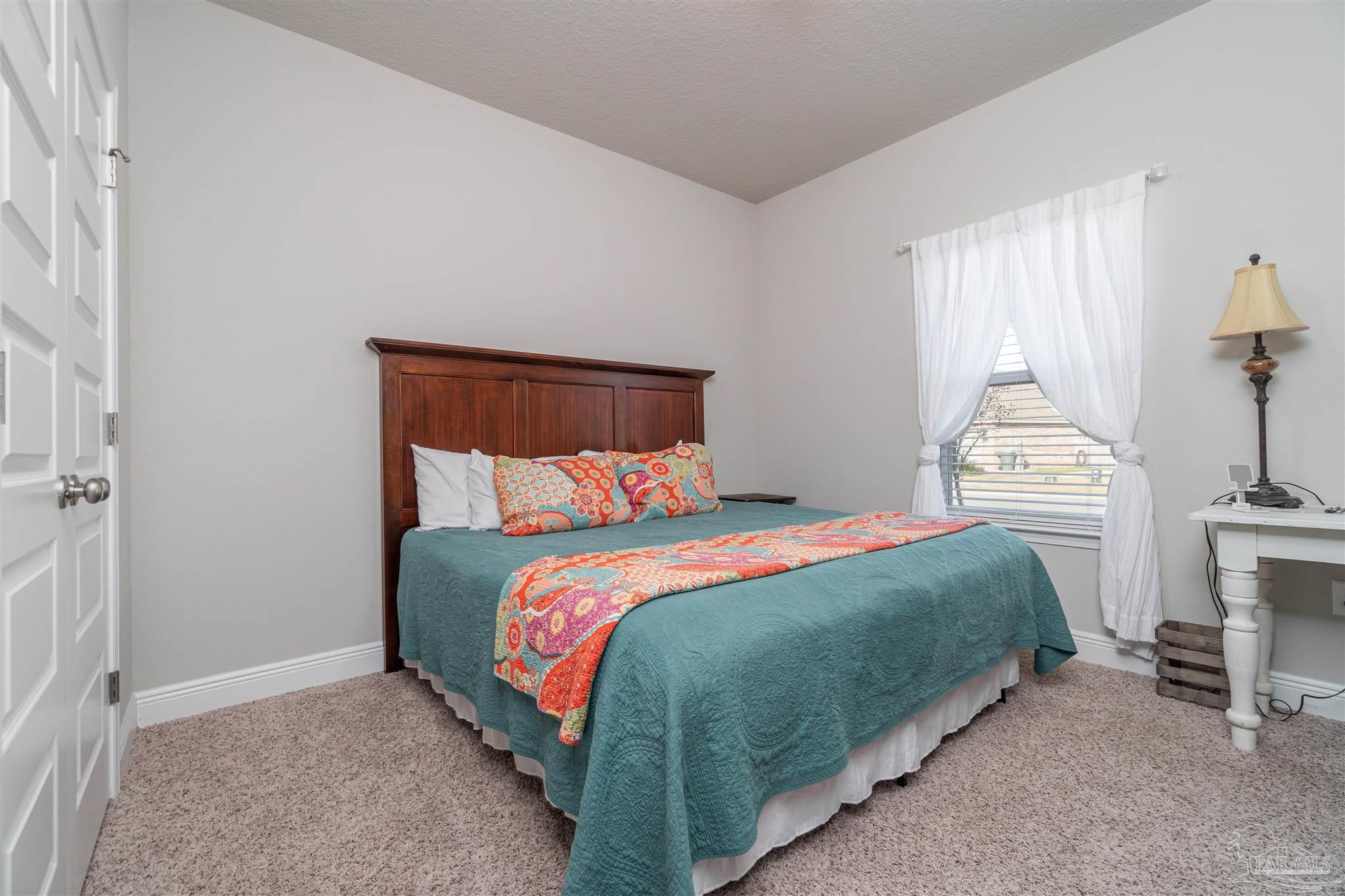 7997 Woodbrook Road Pensacola, FL 32526 - Photo 8 of 35 a bedroom with a bed and a window