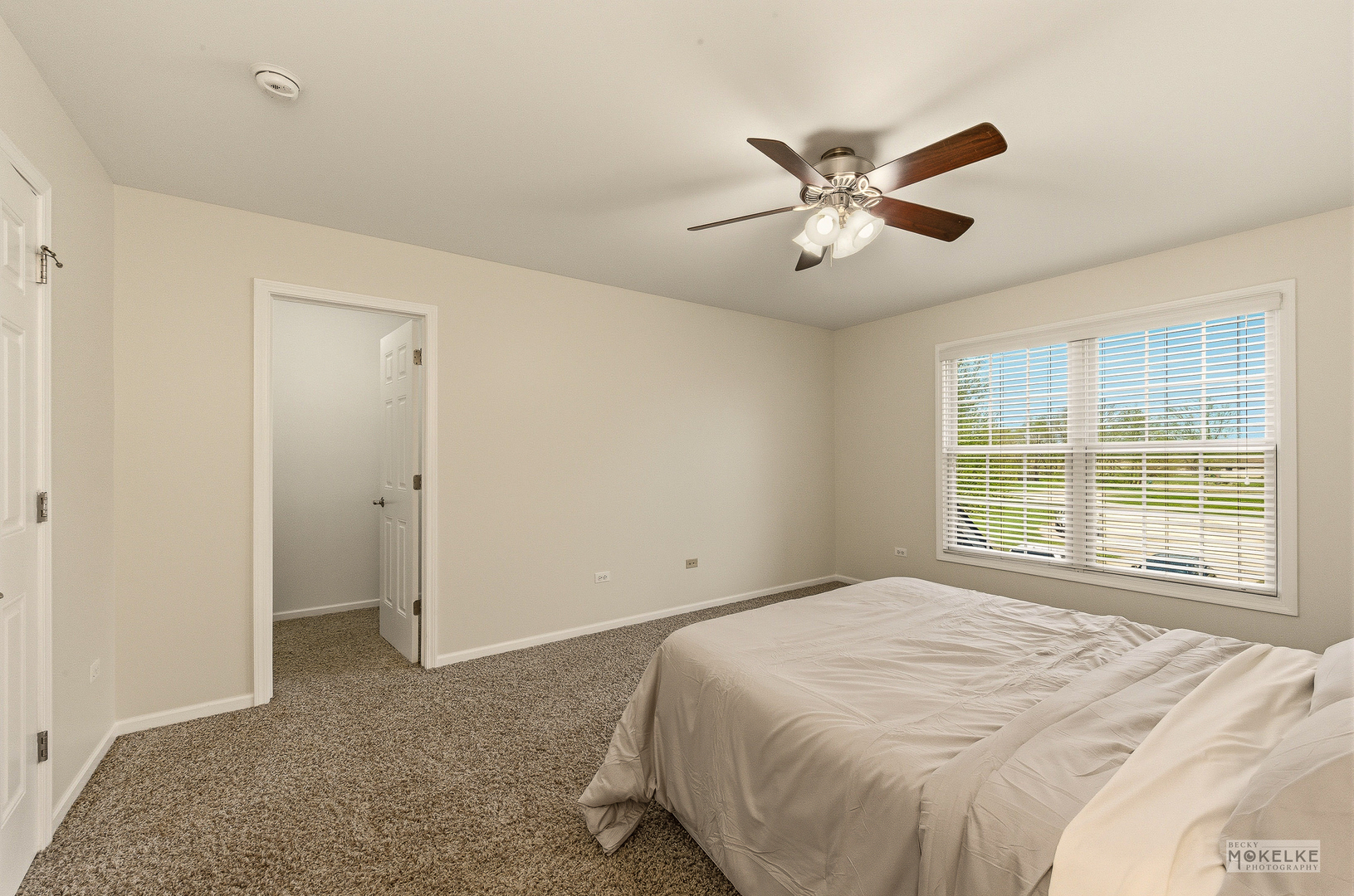 2953 4459th Road Newark, IL 60541 - Photo 30 of 39 a bedroom with a large bed and a ceiling fan