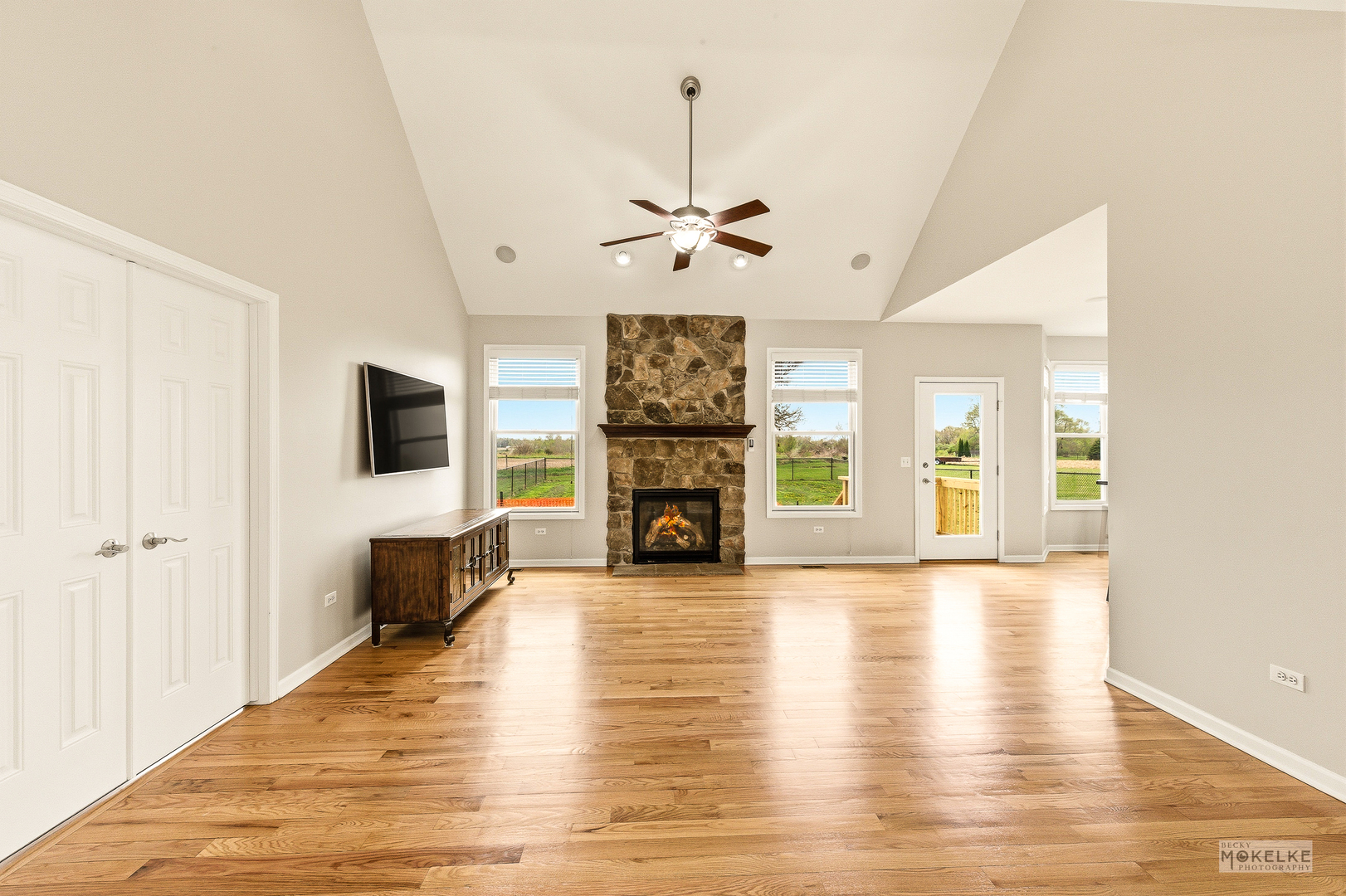 2953 4459th Road Newark, IL 60541 - Photo 9 of 39 a view of a livingroom with a fireplace a chandelier and wooden floor