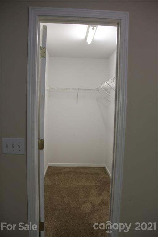 11233 Dickie Ross Road Charlotte, NC 28277 - Photo 13 of 26 a bathroom with a glass shower door