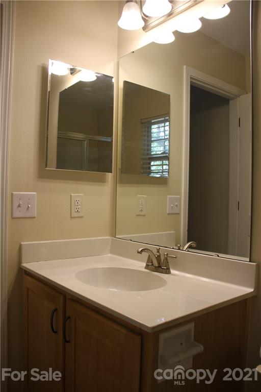 11233 Dickie Ross Road Charlotte, NC 28277 - Photo 18 of 26 a bathroom with a sink vanity and a mirror