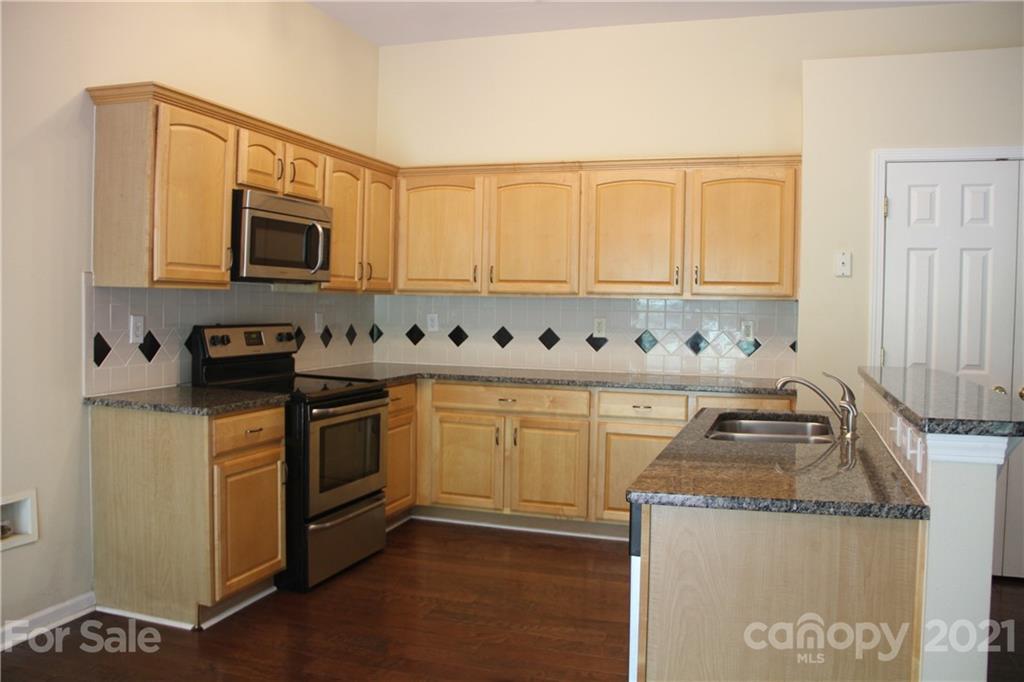 11233 Dickie Ross Road Charlotte, NC 28277 - Photo 6 of 26 a kitchen with granite countertop cabinets stainless steel appliances and a sink