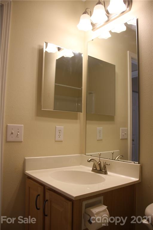 11233 Dickie Ross Road Charlotte, NC 28277 - Photo 10 of 26 a bathroom with a sink and a mirror