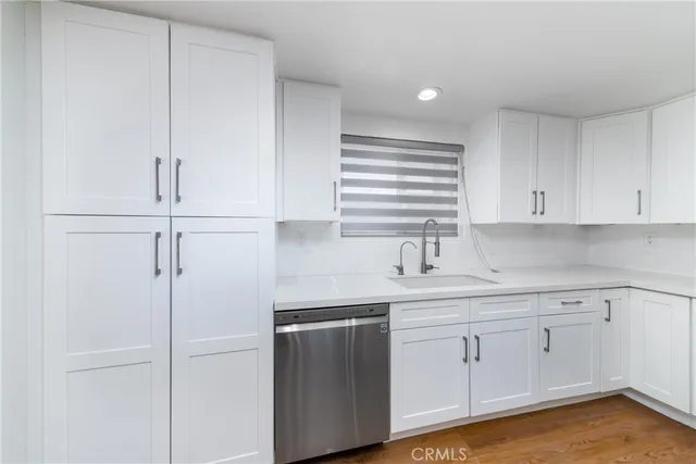 a kitchen with white cabinets and white appliances