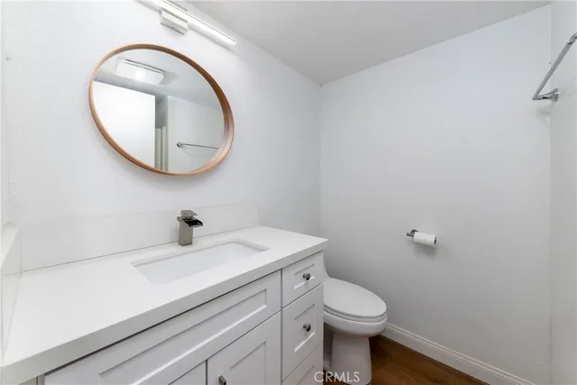 a bathroom with a sink a toilet and a mirror