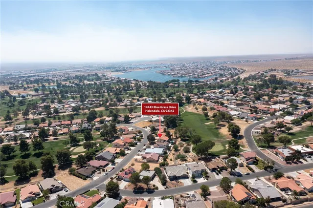 an aerial view of a house with garden space and street view