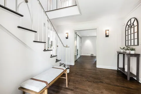 a room with wooden floor and stairs
