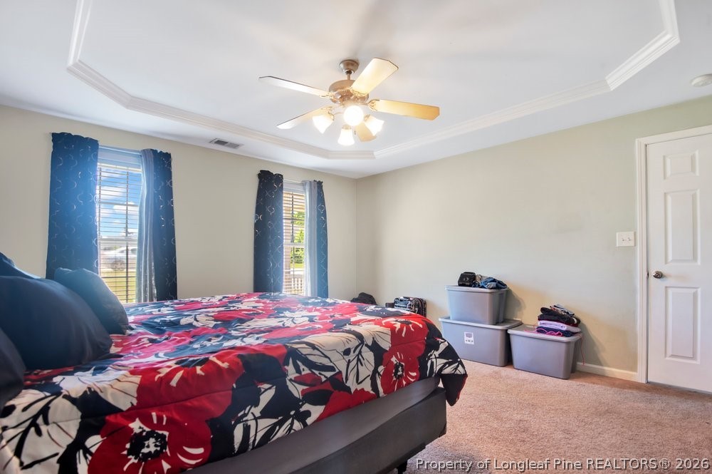 10 Pender Road Spring Lake, NC 28390 - Photo 23 of 35 a bedroom with a bed and a chandelier