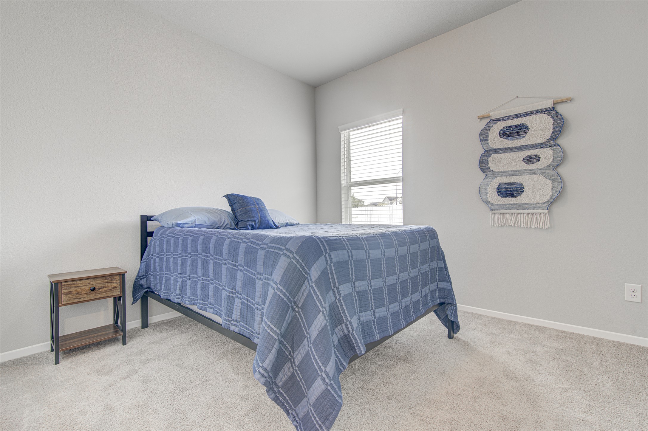 156 Tillage Road Elgin, TX 78621 - Photo 16 of 25 Comfortable bedroom offers soft carpeting and natural light through the window.