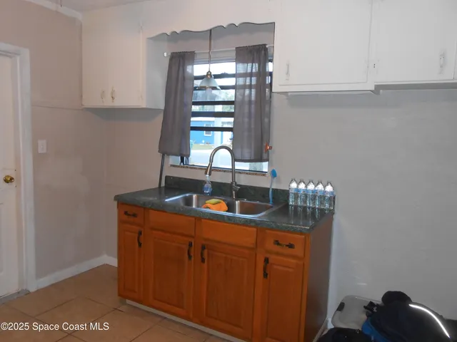 a kitchen with granite countertop wood cabinets stainless steel appliances and a sink