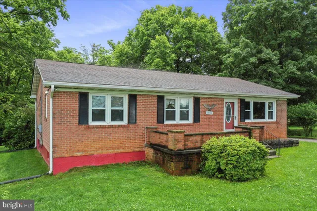 a aerial view of a house with a yard table and chairs