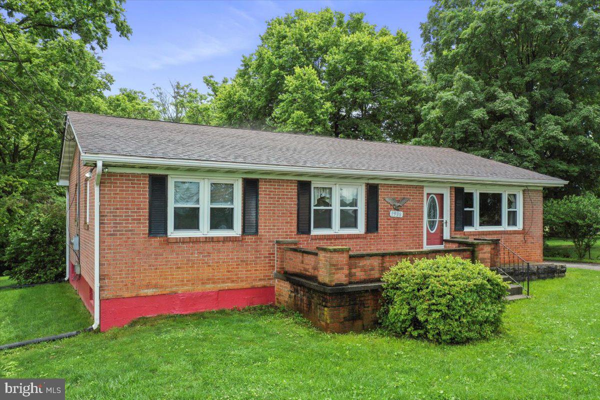 a aerial view of a house with a yard table and chairs
