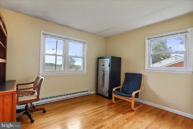 a view of a workspace with furniture and a window