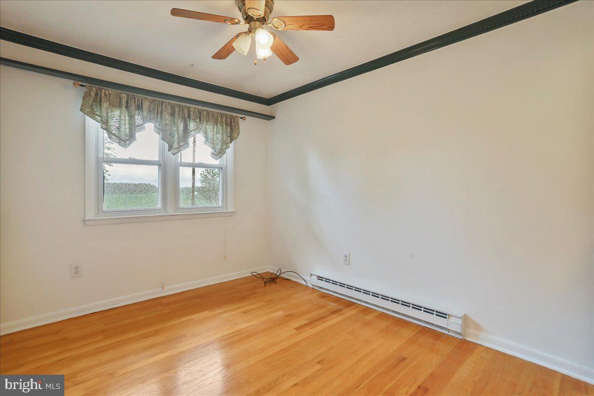 1956 Cattail Run Road Charles Town, WV 25414 - Photo 14 of 29 a view of empty room with wooden floor and fan