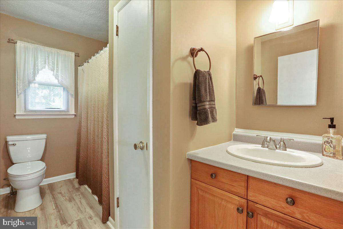 1956 Cattail Run Road Charles Town, WV 25414 - Photo 17 of 29 a bathroom with a toilet sink and mirror