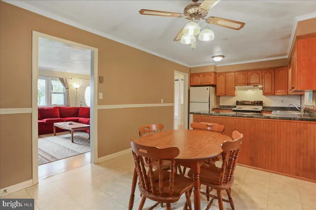 a dining room dining table chairs and a refrigerator
