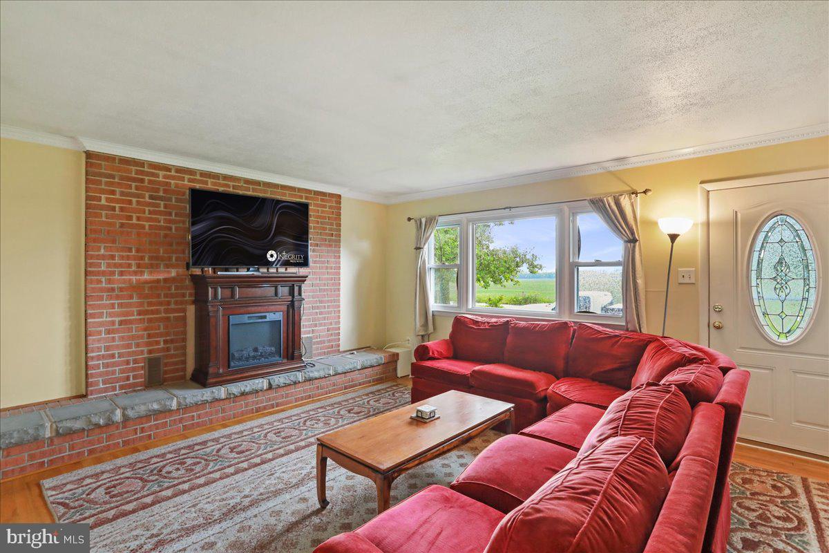 1956 Cattail Run Road Charles Town, WV 25414 - Photo 7 of 29 a living room with furniture a flat screen tv and a fireplace