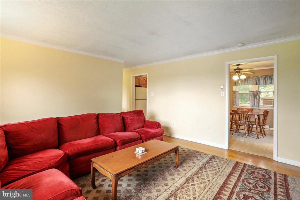 1956 Cattail Run Road Charles Town, WV 25414 - Photo 8 of 29 a blue couch sitting in a living room next to a window