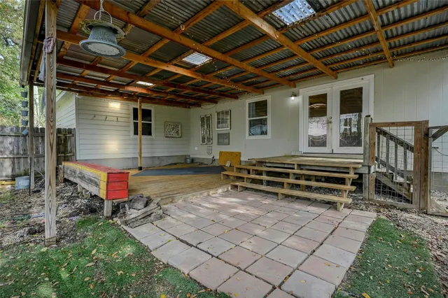a view of a park with wooden bench and trees