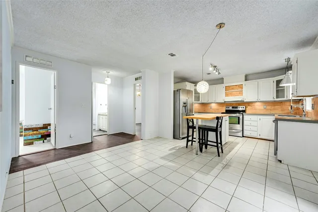 a kitchen with a table and chairs in it