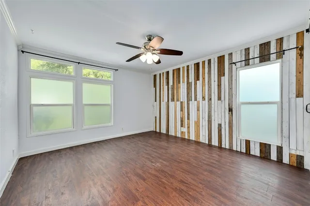 a view of an empty room with wooden floor