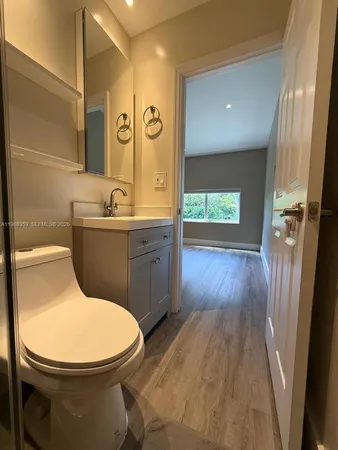 a bathroom with a toilet sink and mirror