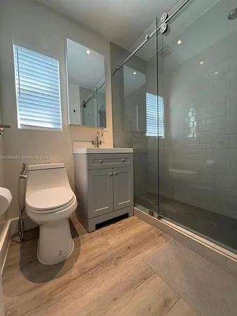 a bathroom with a toilet sink and shower