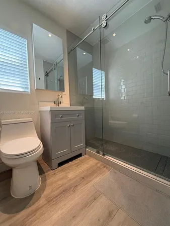 a bathroom with a shower and a sink