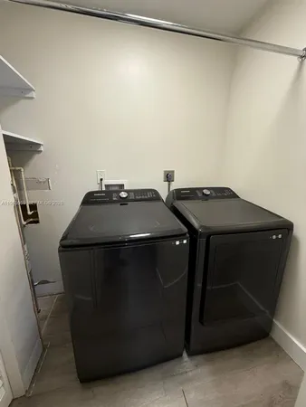 a utility room with washer and dryer