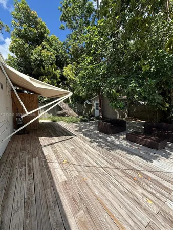 a view of a backyard with wooden floor
