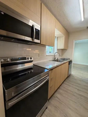 a kitchen with a sink and a refrigerator