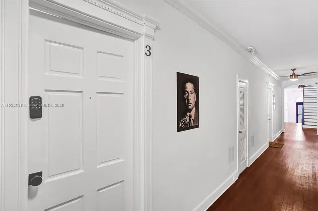 a view of a hallway with wooden floor